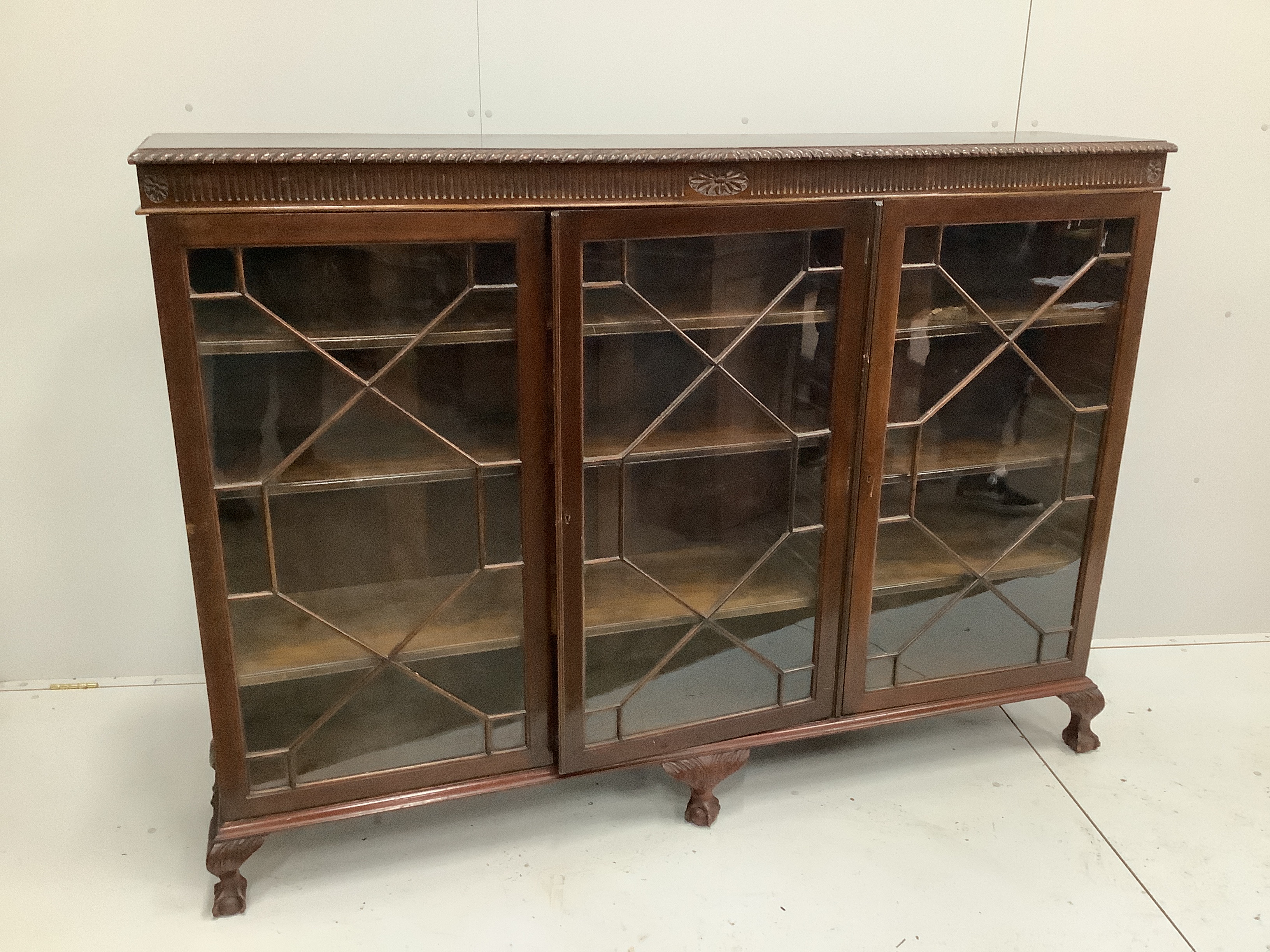 A 1920’s Chippendale revival glazed mahogany bookcase, width 183cm, depth 38cm, height 132cm